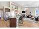 Open-concept living space with high ceilings, fireplace, kitchen island, and ample natural light at 2065 Sage Grouse Way, Castle Rock, CO 80109