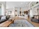 Spacious living room with open layout to kitchen and dining area, complemented by a large area rug at 2065 Sage Grouse Way, Castle Rock, CO 80109
