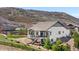 Home exterior with a backyard featuring a patio area, lush green grass, and a wood fence at 2065 Sage Grouse Way, Castle Rock, CO 80109