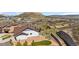 View of the home's rear exterior featuring an outdoor living space, gravel landscaping, and a retaining wall at 2065 Sage Grouse Way, Castle Rock, CO 80109