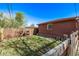 Cozy backyard featuring a detached garage, green grass, and wood fence at 2291 W 54Th Ave, Denver, CO 80221