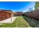 Expansive backyard with well-maintained lawn, patio area, garage, and secure fencing at 2291 W 54Th Ave, Denver, CO 80221