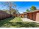 A beautiful backyard featuring a lush lawn, patio space, and a swing set at 2291 W 54Th Ave, Denver, CO 80221