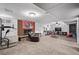 Finished basement with a fireplace, seating, play area, and exercise equipment provides versatile recreational space at 2291 W 54Th Ave, Denver, CO 80221