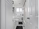 Bathroom with black and white marble tile, black hardware, and a shower/tub combo at 2291 W 54Th Ave, Denver, CO 80221