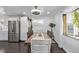 Inviting dining area with a modern chandelier, stainless steel appliances, and a stylish design at 2291 W 54Th Ave, Denver, CO 80221
