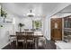 Charming dining area with a wooden table, ample seating, and natural lighting at 2291 W 54Th Ave, Denver, CO 80221