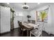 Cozy dining area with a rustic table, sheer curtains, and a decorative chandelier at 2291 W 54Th Ave, Denver, CO 80221