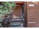 Home's brick entrance with wrought iron railings and a shaded porch at 2291 W 54Th Ave, Denver, CO 80221