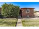 Classic brick home with mature landscaping and a fenced front yard at 2291 W 54Th Ave, Denver, CO 80221
