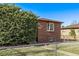 Traditional brick house with a bay window, surrounded by a lush green lawn at 2291 W 54Th Ave, Denver, CO 80221