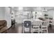 Bright kitchen featuring white cabinets, stainless steel appliances, and island seating at 2291 W 54Th Ave, Denver, CO 80221