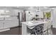 Bright kitchen features a large island, stainless steel appliances, white cabinets and modern fixtures at 2291 W 54Th Ave, Denver, CO 80221