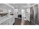 Spacious open-concept kitchen with white cabinets, modern appliances, and an island at 2291 W 54Th Ave, Denver, CO 80221