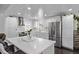 Updated kitchen featuring a large stainless steel refrigerator, white cabinets, and an island at 2291 W 54Th Ave, Denver, CO 80221