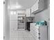 Functional laundry area with white cabinets, shelves, and counter space for folding and storage at 2291 W 54Th Ave, Denver, CO 80221