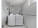 Laundry room with modern washer and dryer set against a clean, tiled floor and painted walls at 2291 W 54Th Ave, Denver, CO 80221