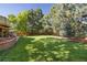 Expansive backyard featuring well-maintained lawn and mature trees at 8812 Blue Mountain Pl, Highlands Ranch, CO 80126