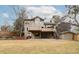 Large backyard featuring a lawn, mature trees, brick accents, covered patio, second story deck, and outbuilding at 8812 Blue Mountain Pl, Highlands Ranch, CO 80126