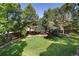 Lush green backyard, framed by mature trees, offering a serene outdoor space at 8812 Blue Mountain Pl, Highlands Ranch, CO 80126