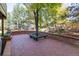 Backyard patio featuring brick paving and a built-in bench around a mature tree at 8812 Blue Mountain Pl, Highlands Ranch, CO 80126