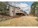 Spacious backyard featuring a large lawn, mature trees, patio, deck, brick accents and outbuilding at 8812 Blue Mountain Pl, Highlands Ranch, CO 80126