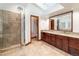 Bathroom featuring a double vanity, tiled floor and a glass-enclosed shower at 8812 Blue Mountain Pl, Highlands Ranch, CO 80126