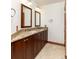 Bathroom featuring a double vanity with granite counters and tile flooring at 8812 Blue Mountain Pl, Highlands Ranch, CO 80126