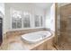 Bathroom featuring a soaking tub, tiled shower and decorative tile work at 8812 Blue Mountain Pl, Highlands Ranch, CO 80126