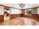 Formal dining room featuring hardwood floors, wainscoting, and a chandelier at 8812 Blue Mountain Pl, Highlands Ranch, CO 80126