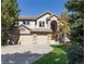 Stately two-story home boasts a three-car garage, brick accents, and mature landscaping in a suburban setting at 8812 Blue Mountain Pl, Highlands Ranch, CO 80126