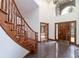 Grand foyer features a curved staircase, high ceilings, dark tile flooring, and a stylish front door with glass inserts at 8812 Blue Mountain Pl, Highlands Ranch, CO 80126