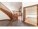 Elegant foyer showcases a curved staircase, open layout, dark tile flooring, and a glimpse into the adjoining living spaces at 8812 Blue Mountain Pl, Highlands Ranch, CO 80126