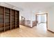 Hallway with hardwood floors and built-in shelving at 8812 Blue Mountain Pl, Highlands Ranch, CO 80126