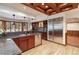 Kitchen with stainless steel refrigerator, granite countertops, custom wood cabinets and coffered ceilings at 8812 Blue Mountain Pl, Highlands Ranch, CO 80126