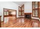 Spacious living room with hardwood floors, fireplace, and large windows with custom wooden shutters at 8812 Blue Mountain Pl, Highlands Ranch, CO 80126