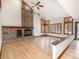 Living room with high ceilings, brick fireplace, many windows, and wood floors at 8812 Blue Mountain Pl, Highlands Ranch, CO 80126