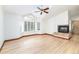 Main bedroom featuring a fireplace, hardwood floors, and large windows at 8812 Blue Mountain Pl, Highlands Ranch, CO 80126