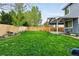 Well-maintained backyard features a lush lawn, wooden fence, and a covered patio at 14194 W Amherst Ave, Lakewood, CO 80228