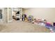 Spacious finished basement featuring carpeted floors, open play area, and white-framed doors at 14194 W Amherst Ave, Lakewood, CO 80228