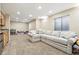 Finished basement with plush carpet, a large sectional sofa, and recessed lighting at 14194 W Amherst Ave, Lakewood, CO 80228