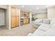 Spacious finished basement featuring a seating area, a wet bar, and neutral carpet at 14194 W Amherst Ave, Lakewood, CO 80228
