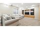 Finished basement featuring carpeted floors, recessed lighting, and a comfortable gray sofa at 14194 W Amherst Ave, Lakewood, CO 80228
