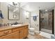 Cozy bathroom features a wooden vanity, stone accents, and a tiled walk-in shower at 14194 W Amherst Ave, Lakewood, CO 80228