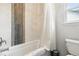 Bathroom featuring a tiled tub/shower combo and a new toilet at 14194 W Amherst Ave, Lakewood, CO 80228