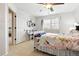 Bedroom with white walls, ceiling fan, desk and large window providing natural light at 14194 W Amherst Ave, Lakewood, CO 80228