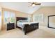 Spacious bedroom featuring vaulted ceilings, large windows, and a dark wood furniture set at 14194 W Amherst Ave, Lakewood, CO 80228