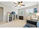 Bright carpeted bedroom with a ceiling fan, white shelving unit, and shuttered window at 14194 W Amherst Ave, Lakewood, CO 80228