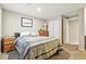 Bedroom features neutral walls, carpeted floors, a window, closet, and dresser at 14194 W Amherst Ave, Lakewood, CO 80228