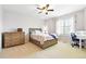 Cozy bedroom with a ceiling fan, neutral carpet and light colored walls at 14194 W Amherst Ave, Lakewood, CO 80228